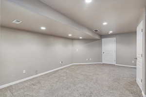 Finished below grade area featuring carpet floors and recessed lighting