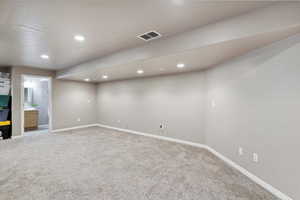 Finished basement featuring light colored carpet and recessed lighting