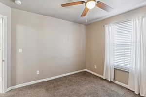 Unfurnished room with carpet, a smoke detector, and a ceiling fan