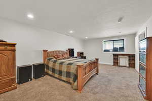 Bedroom featuring carpet floors, recessed lighting, and a textured ceiling