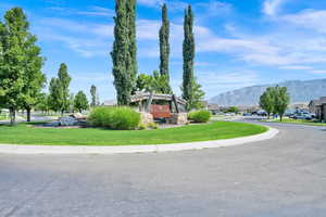 View of front facade featuring a mountain view, a front lawn, and a residential view