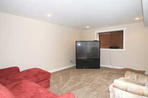 Carpeted living room featuring recessed lighting
