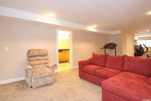 Living area featuring light colored carpet and recessed lighting