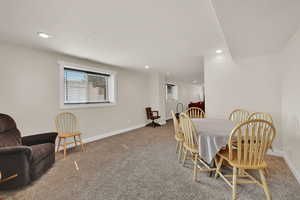 Carpeted dining area featuring plenty of natural light and recessed lighting