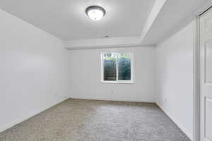 Carpeted spare room with baseboards