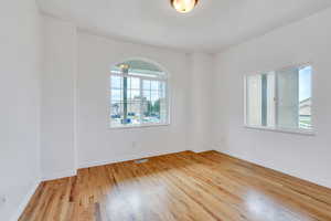 Empty room featuring wood finished floors and baseboards
