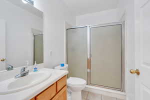 Bathroom featuring vanity, a shower stall, and tile patterned floors