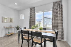 Dining space with light wood-style flooring and recessed lighting