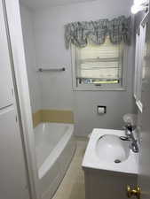 Bathroom with a bath and vanity