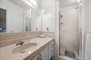 Bathroom with a stall shower and vanity