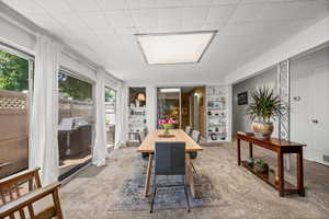 Dining room with built in shelves and healthy amount of natural light