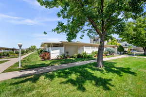 View of front of home featuring brick siding and a front lawn