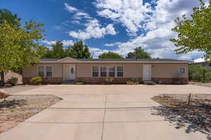 View of front of home with stone siding and driveway