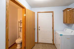 Laundry room featuring washer / dryer and light tile patterned floors