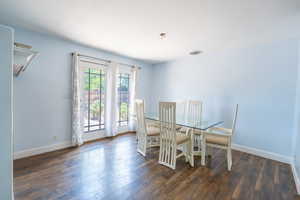 Dining area with hardwood / wood-style flooring and baseboards