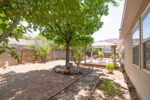 Fenced backyard with a gazebo and a wooden deck