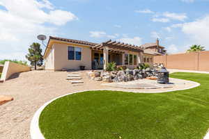 Back of house with a pergola, a tiled roof, a fenced backyard, a patio, and stucco siding