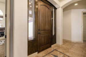 Entrance foyer featuring baseboards and recessed lighting
