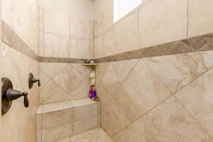 Bathroom featuring a tile shower