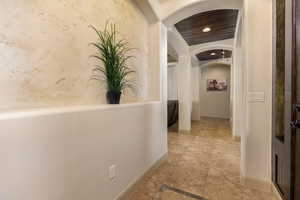 Corridor with arched walkways and recessed lighting
