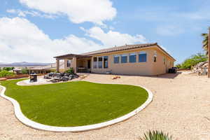 Back of property featuring a pergola, a patio, a tile roof, stucco siding, and a yard