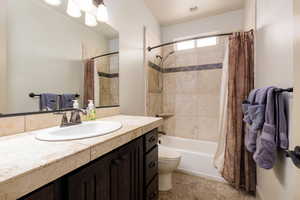 Bathroom with vanity and shower / tub combo with curtain