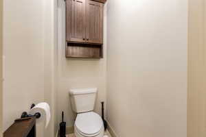 Bathroom featuring baseboards and toilet