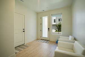Foyer featuring baseboards and light wood-style flooring