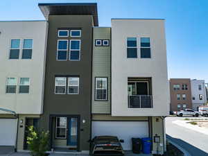 View of property featuring stucco siding and an attached garage
