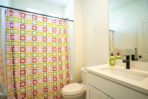 Full bathroom with vanity and a shower with shower curtain