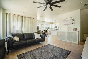 Living room with light wood-style floors and a ceiling fan