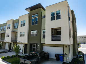 View of front of home featuring stucco siding, a garage, and concrete driveway