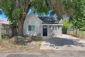 View of front of house featuring roof with shingles and board and batten siding