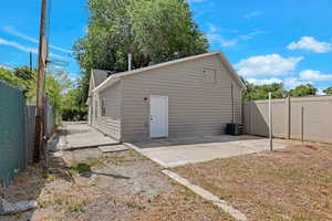 Rear view of property featuring a patio area and a fenced backyard