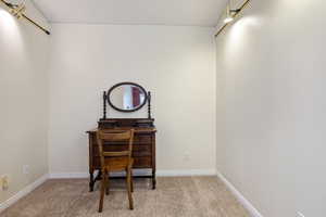 Carpeted office space featuring baseboards