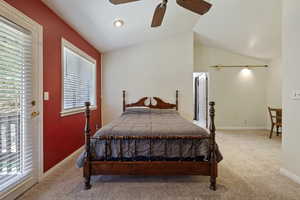 Bedroom with lofted ceiling, carpet flooring, and ceiling fan
