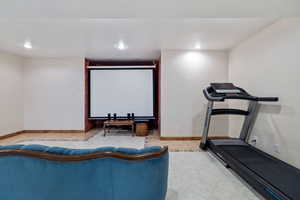 Workout area with recessed lighting and light tile patterned floors