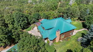 View from above of property featuring a heavily wooded area