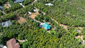 Aerial view of property's location featuring a heavily wooded area