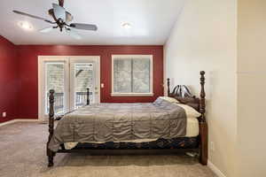 Carpeted bedroom featuring access to outside and a ceiling fan
