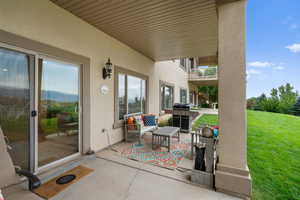 Patio / terrace featuring a patio, a lawn, and a grill
