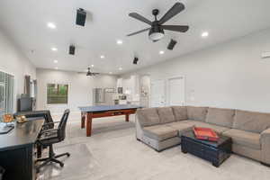 Living room featuring a ceiling fan, recessed lighting, and light colored carpet