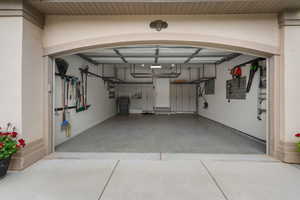 Garage with baseboards and a garage door opener