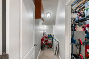 Hall with carpet flooring and a textured ceiling
