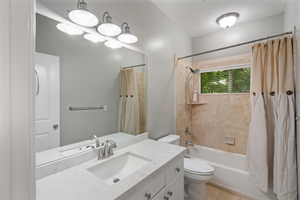 Bathroom with vanity, shower / bath combination with curtain, and tile patterned floors