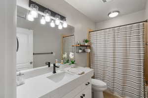 Full bathroom with vanity, a shower with shower curtain, and tile patterned floors