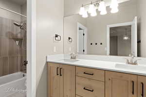 Full bath with double vanity and shower / washtub combination