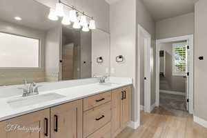 Bathroom with double vanity and a tile shower