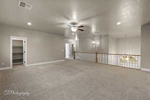 Spare room featuring ceiling fan, light colored carpet, recessed lighting, and a textured ceiling