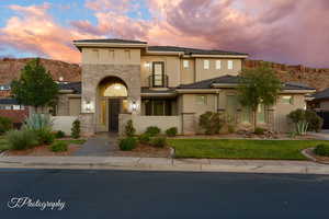 View of front of property featuring stone siding and stucco siding